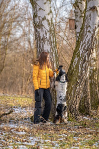 Rear view of woman standing in forest