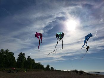 Low angle view of flags on field against sky