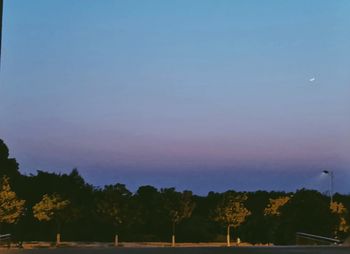 Scenic view of silhouette trees against sky at sunset