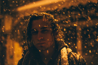 Portrait of young man on rainy day