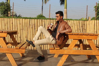 Young man sitting on seat