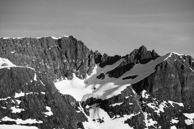 Scenic view of snow covered mountains against sky