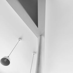 Low angle view of electric lamp hanging on ceiling