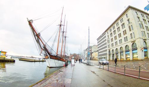 Panoramic view of harbor against sky in city