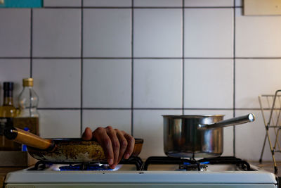 Close-up of hand on table against wall