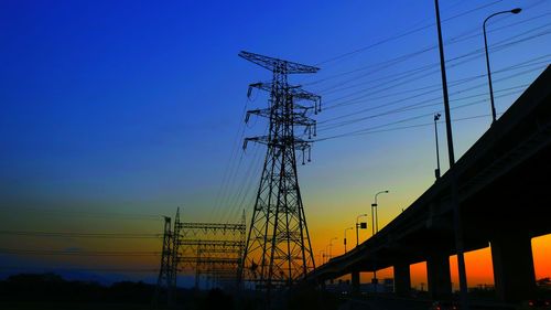 Low angle view of electricity pylon against sky