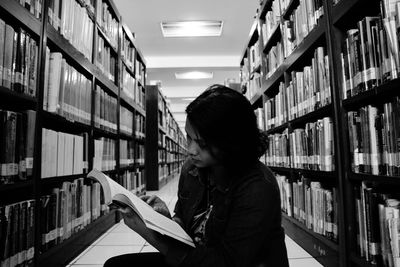 Full length of a young man reading book