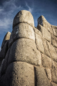 Low angle view of stone structure against sky