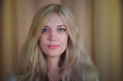 Portrait of beautiful woman with blond hair at home