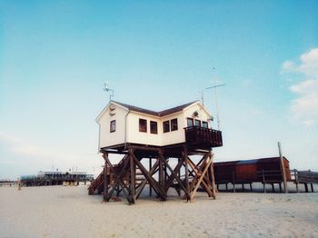 Lifeguard hut on beach against sky