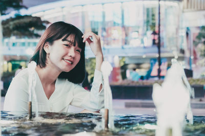 Portrait of a smiling young woman at table