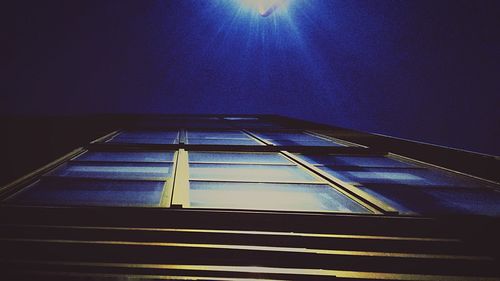 Low angle view of modern building against blue sky