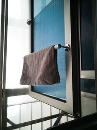 Kitchen microfiber cloth drying at the window mounted aluminium and pvc pipe towel rack.
