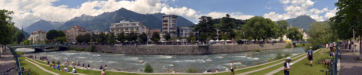 Panoramic view of people on street amidst buildings in city