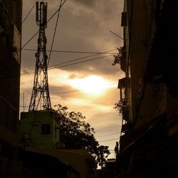 Low angle view of silhouette buildings against sky during sunset