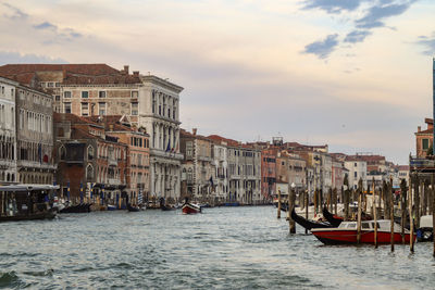 Boats in sea against buildings in city