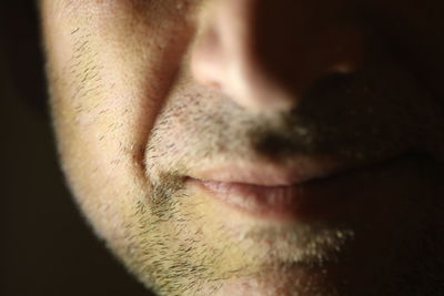 Close-up of man eye against black background