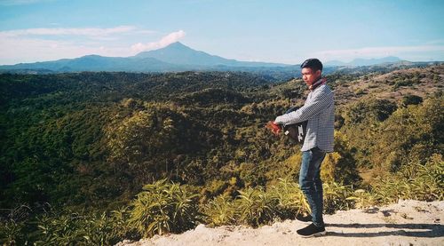 Man looking away while standing on mountain