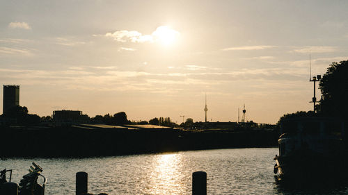 Scenic view of silhouette city against sky during sunset