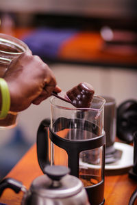 Cropped hand pouring coffee