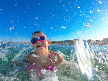 Portrait of smiling man splashing in sea