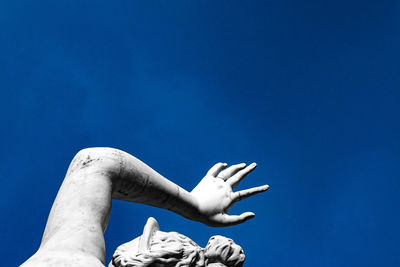 Low angle view of statue against clear blue sky