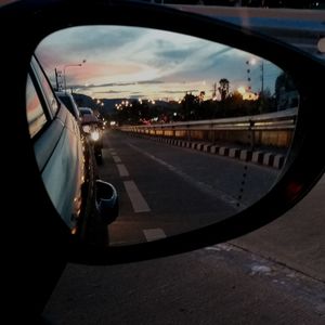 Reflection of sky on side-view mirror