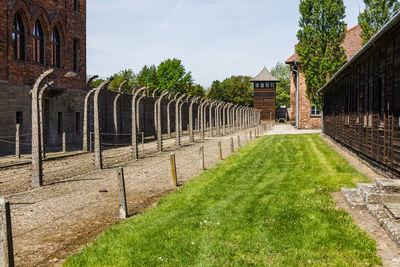 Barbed wire and watchtower around the auschwitz-birkenau concentration camp.  poland, 16 may 2022