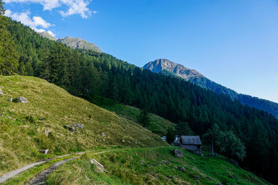 Scenic view of mountains against blue sky