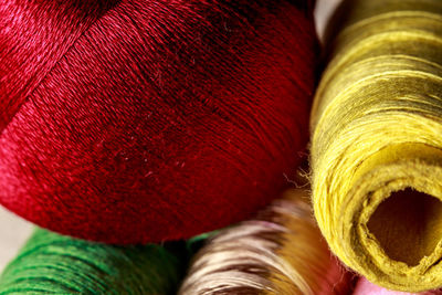 Close-up of thread spools and ball of wool