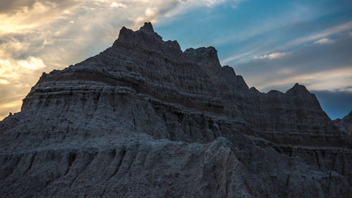 Low angle view of rock formation against sky