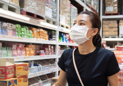 Portrait of woman standing at store