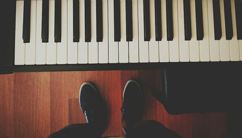 Low section of person on hardwood floor
