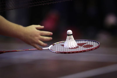 Cropped hand playing badminton