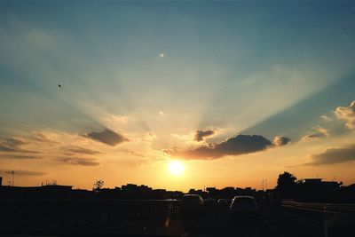 Silhouette city against sky during sunset