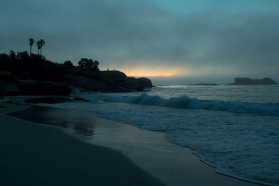 Scenic view of beach against sky during sunset