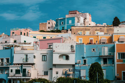 Buildings in town against sky