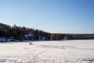 Scenic view of frozen lake with fishermen. icefishing 