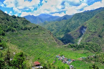 Scenic view of mountains against cloudy sky