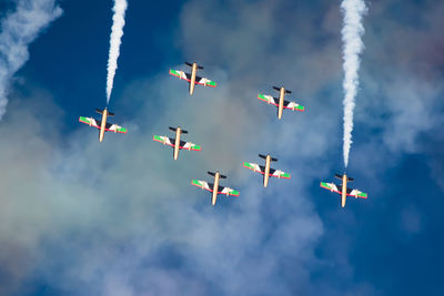 Low angle view of airshow against sky