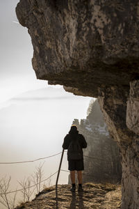Rear view of man photographing rock