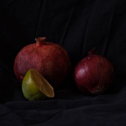 Close-up of  fruits on table against black background