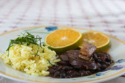 Close-up of chopped fruits in plate on table