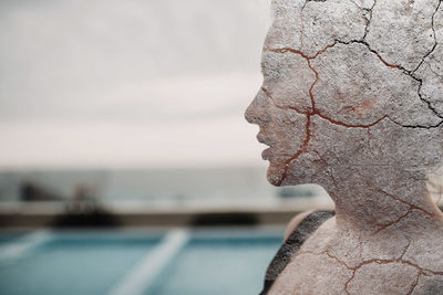 Close-up portrait of man against sea