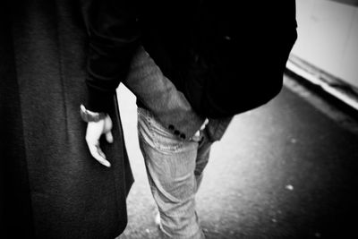 Low section of man standing on street