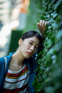 Portrait of young woman standing outdoors