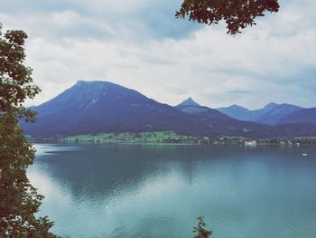 Scenic view of lake and mountains against sky