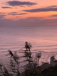 Scenic view of sea against romantic sky at sunset