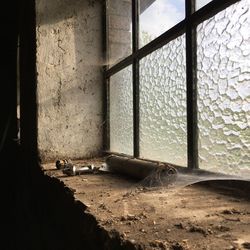 Abandoned building seen through window