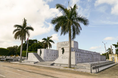 Palm trees and buildings against sky